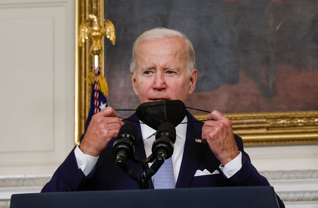 WASHINGTON, DC - JULY 28: U.S. President Joe Biden removes his mask as he deliver remarks on the Inflation Reduction Act of 2022 in the State Dining Room of the White House on July 28, 2022 in Washington, DC. In a major reversal, U.S. Sen. Joe Manchin (D-WV) announced his support for the legislation that includes provisions for climate change, tax hikes on corporations and health care subsidies. (Photo by Anna Moneymaker/Getty Images)