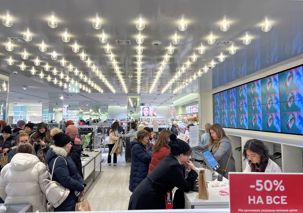 Customers shop at an H&M store in Russia today on its final day of trading there