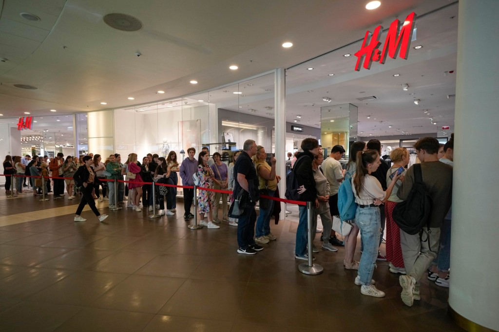 People line up to enter an H&M shop in St Petersburg in August, after the company announced they would close in Russia