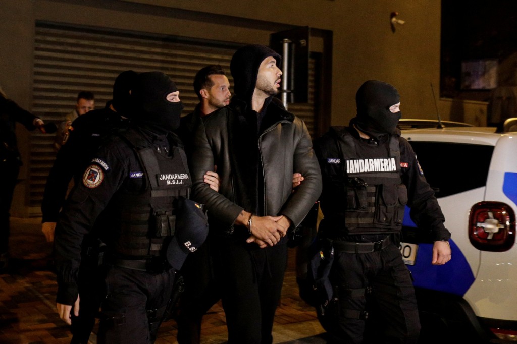 Andrew Tate and Tristan Tate are escorted by police officers outside the headquarters of the Directorate for Investigating Organized Crime and Terrorism in Bucharest (DIICOT) after being detained for 24 hours, in Bucharest,?Romania, December 29, 2022. Inquam Photos/Octav Ganea via REUTERS ATTENTION EDITORS - THIS IMAGE WAS PROVIDED BY A THIRD PARTY. ROMANIA OUT. NO COMMERCIAL OR EDITORIAL SALES IN ROMANIA