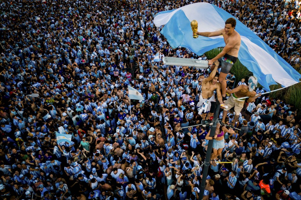 Fans celebrate Argentine winning the World Cup at the Obelisk in Buenos Aires last night