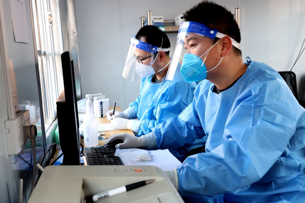 Staff members work at a medical service facility in Lianyungang, in China's eastern Jiangsu province on December 22, 2022. (Photo by AFP) / China OUT (Photo by STR/AFP via Getty Images)