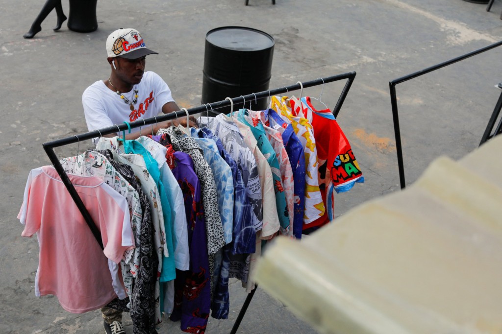 James Dartey, 23, a fashion retailer, displays second-hand clothes for sale during a vintage clothes gala event in Accra, Ghana, December 20, 2022. REUTERS/Francis Kokoroko