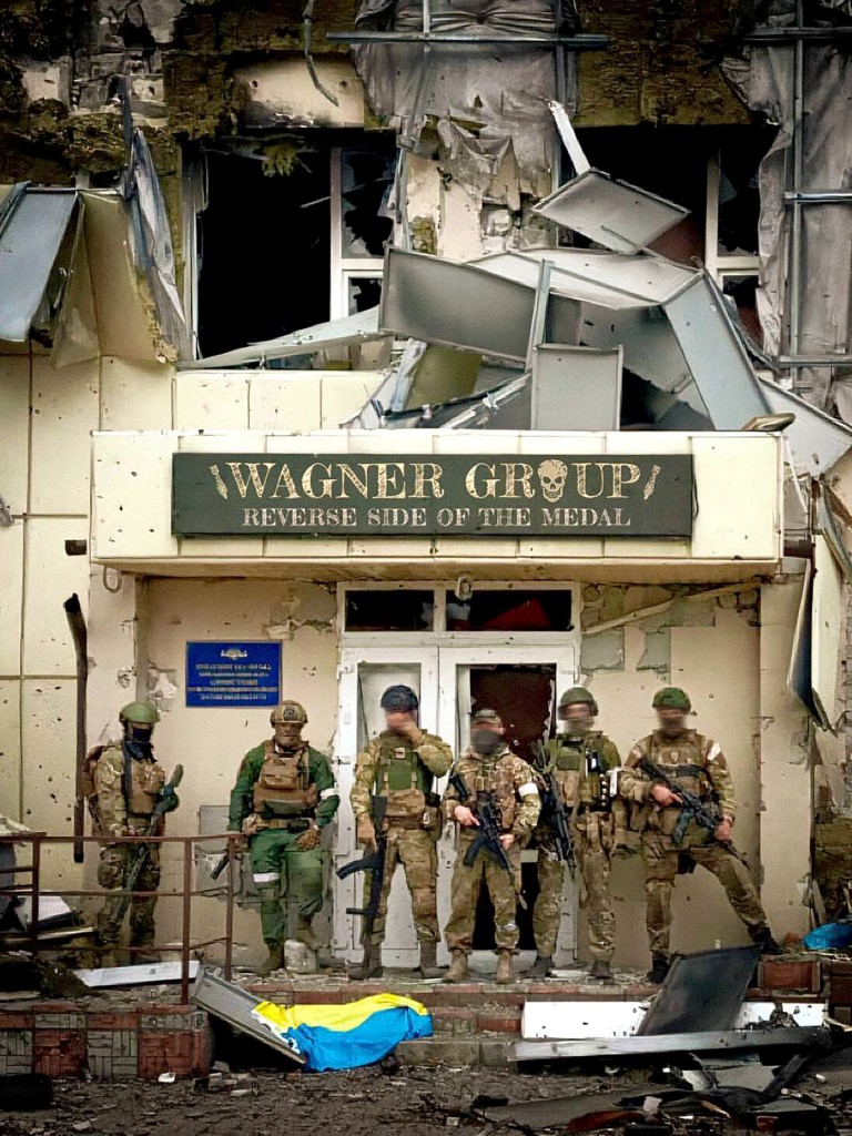 PMC Wagner mercenaries pose at Popasna, the Sievierodonetsk district of the Luhansk Oblast, eastern Ukraine. PMC Wagner mercenaries pose at Popasna, the Sievierodonetsk district of the Luhansk Oblast, eastern Ukraine. The 'WAGNER GROUP - Reverse Side of the Medal' in the middle of the shot was photoshopped by a source that shared the image