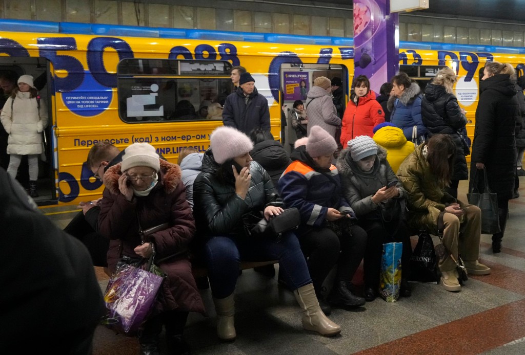 People rest in the subway station, being used as a bomb shelter during a rocket attack in Kyiv, Ukraine, Friday, Dec. 16, 2022. Ukrainian authorities reported explosions in at least three cities Friday, saying Russia has launched a major missile attack on energy facilities and infrastructure. Kyiv Mayor Vitali Klitschko reported explosions in at least four districts, urging residents to go to shelters. (AP Photo/Efrem Lukatsky)