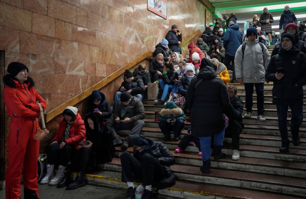 People rest in the subway station, being used as a bomb shelter during a rocket attack in Kyiv, Ukraine, Friday, Dec. 16, 2022. Ukrainian authorities reported explosions in at least three cities Friday, saying Russia has launched a major missile attack on energy facilities and infrastructure. Kyiv Mayor Vitali Klitschko reported explosions in at least four districts, urging residents to go to shelters. (AP Photo/Efrem Lukatsky)