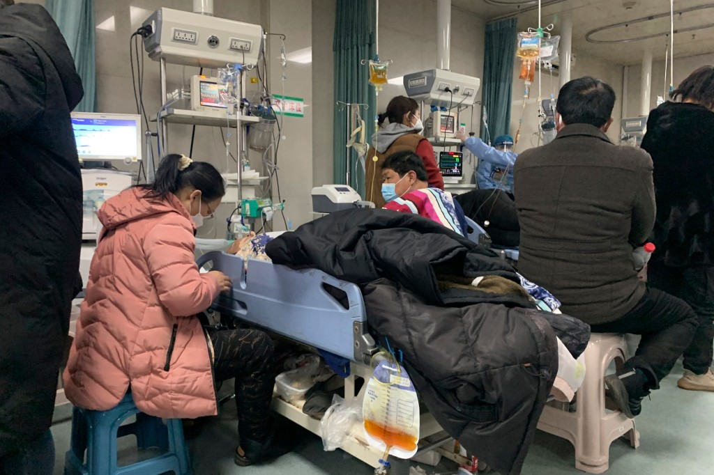 Relatives gather near the beds of sickened patients at the emergency department of the Langfang No. 4 People's Hospital in Bazhou city in northern China's Hebei province on Thursday, Dec. 22, 2022. As China grapples with its first-ever wave of COVID mass infections, emergency wards in the towns and cities to Beijing's southwest are overwhelmed. Intensive care units are turning away ambulances, residents are driving sick relatives from hospital to hospital, and patients are lying on floors for a lack of space. (AP Photo/Dake Kang)