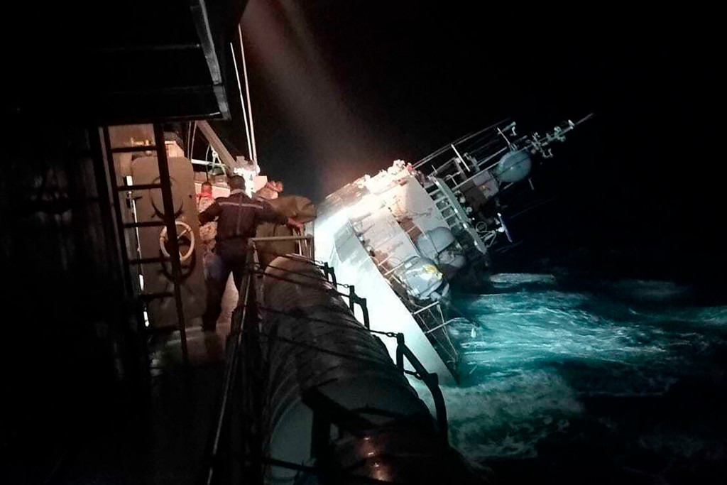 HTMS Sukhothai corvette warship lists off the coast of Prachuap Khiri Khan province, Thailand, Sunday, Dec. 18, 2022. The Thai navy ship sunk in the Gulf of Thailand and ships and helicopters were working Monday to rescue sailors from the water. (Royal Thai Navy via AP)