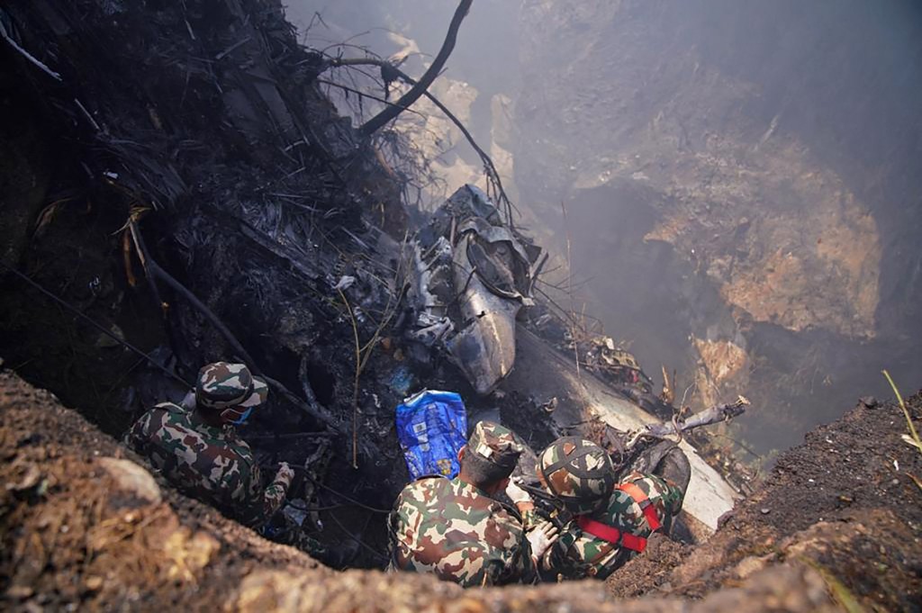 Rescuers inspect the site of a plane crash in Pokhara on January 15, 2023. - An aircraft with 72 people on board crashed in Nepal on January 15, Yeti Airlines and a local official said. (Photo by Yunish Gurung / AFP) (Photo by YUNISH GURUNG/AFP via Getty Images)