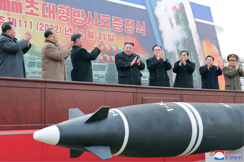 In this photo provided by the North Korean government, North Korean leader Kim Jong Un, center, attends a ceremony of donating 600mm super-large multiple launch rocket system at a garden of the Workers??? Party of Korea headquarters in Pyongyang, North Korea Saturday, Dec. 31, 2022. Independent journalists were not given access to cover the event depicted in this image distributed by the North Korean government. The content of this image is as provided and cannot be independently verified. Korean language watermark on image as provided by source reads: