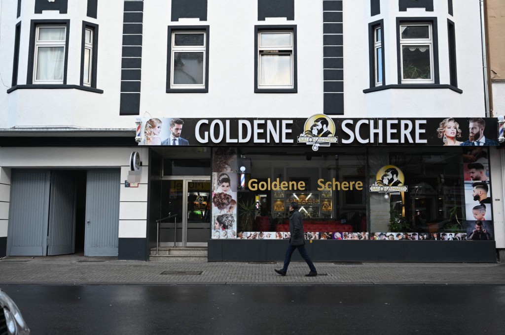 A man walks past a house in Castrop-Rauxel, western Germany, January 8, 2023, where police arrested a 32-year-old Iranian man on suspicion of