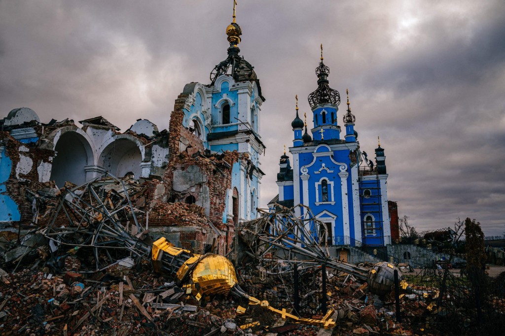 TOPSHOT - Construction workers climb onto the roof of a destroyed church in the village of Bohorodychne, Donetsk region on January 4, 2023, amid the Russian invasion of Ukraine. - Bohorodychne is a village in Donetsk region that came under heavy attack by Russian forces in June 2022, during the Russian invasion of Ukraine. On August 17, 2022 the Russian forces captured the village. The Armed Forces of Ukraine announced on September 12, 2022 that they took back the control over the village. A few resident came back to restore their destroyed houses and live in the village. (Photo by Dimitar DILKOFF / AFP) (Photo by DIMITAR DILKOFF/AFP via Getty Images)