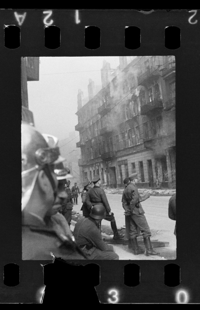 This handout negative dated on April 20, 1943, and taken by Polish firefighter Zbigniew Leszek Grzywaczewski negative shows houses that were abandoned by the Jewish population as they were evacuated being set on fire during the uprising of the Warsaw ghetto in 1943, Poland. On Wednesday, Jan. 18, 2023, Warsaw???s Jewish history museum presented a group of photographs taken in secret during the Warsaw Ghetto Uprising of 1943, some of which have never been seen before, that were recently discovered in a family collection. (Z. L. Grzywaczewski/courtesy of Maciej Grzywaczewski/POLIN Museum via AP)