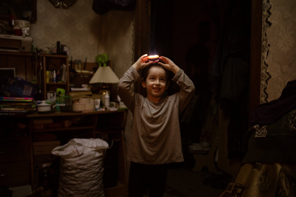 BAKHMUT, UKRAINE - DECEMBER 21: A Ukrainian boy is seen at a family house in Bakhmut, Ukraine on December 21, 2022. Sergei's wife Ira, his five-year-old son, Kolya, and her mother, Nina, live together. They almost never go out because of bombs. (Photo by Andre Luis Alves/Anadolu Agency via Getty Images)