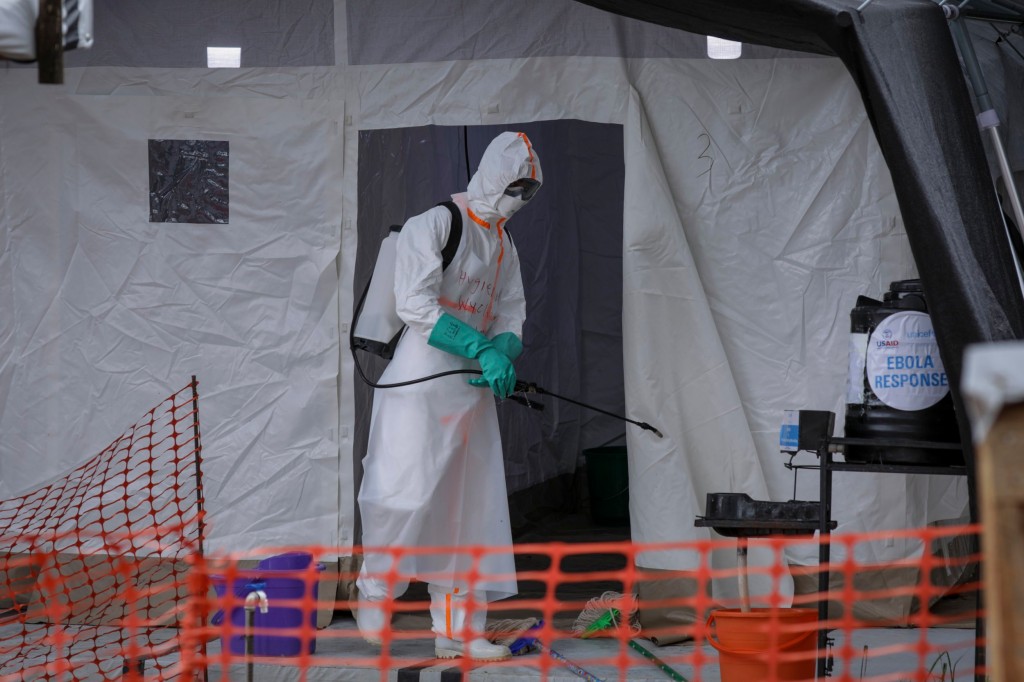 FILE - A medical worker disinfects a tent used for suspected Ebola victims inside the Ebola isolation center of Madudu Health Center III, in the village of Madudu, in the Mubende district of Uganda on Nov. 1, 2022. Uganda's latest outbreak of the Ebola virus is over, the government and the World Health Organization announced Wednesday, Jan. 11, 2023. (AP Photo/Hajarah Nalwadda, File)