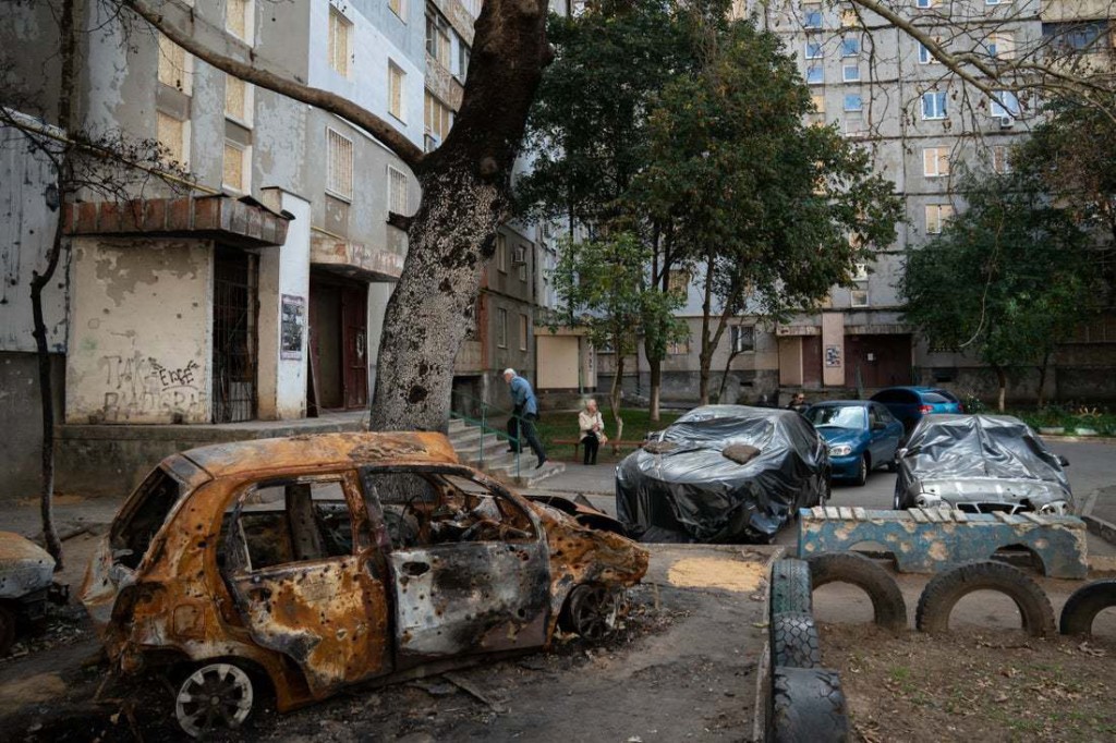 Snapshot - Ukraine 1 year on A damaged car lies unused outside flats with boarded-up windows in Mykolaiv. Such scenes of destruction are common across Ukraine, where blackouts and dwindling resources leave local people vulnerable. Marysia Zapasnik, IRC Country Director, says: ?Over 18 million people in Ukraine are in need of humanitarian assistance, and millions of lives are facing ever-increasing risk.?