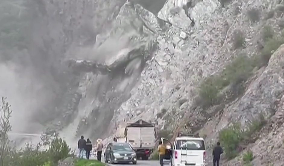 Terrifying moment landslide takes out road as motorists exit vehicles and run Credit REUTERS
