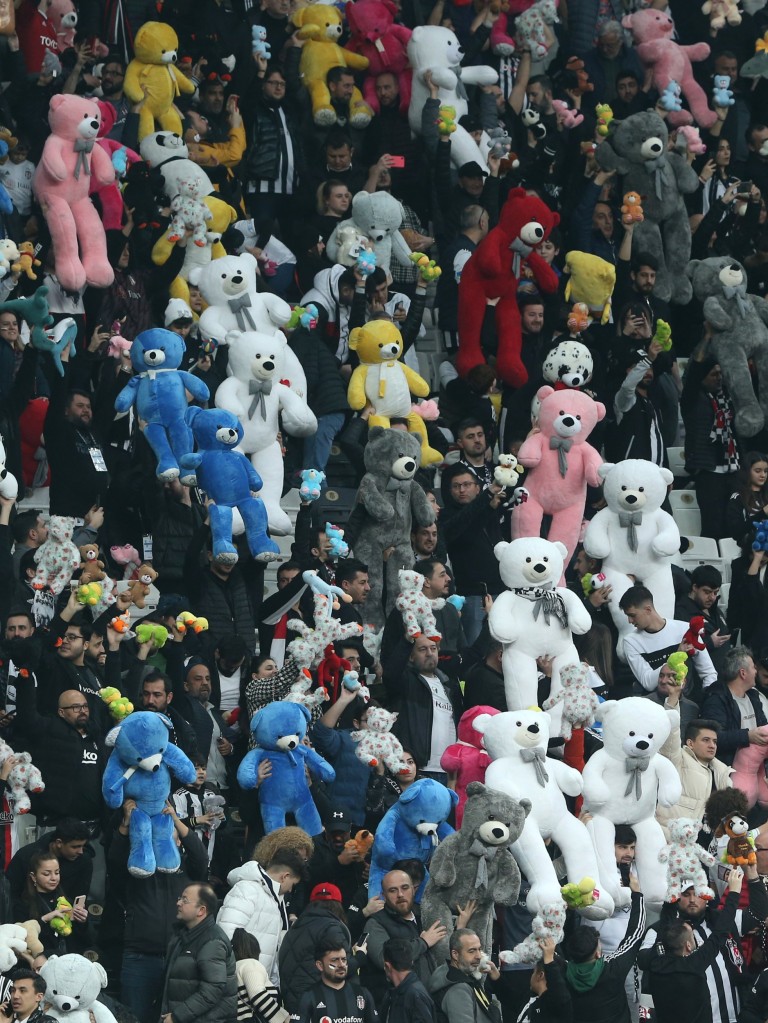 ISTANBUL, TURKIYE- FEBRUARY 26: Fans of Besiktas and hold up Teddy bears before throwing them on to the field in support for earthquake victim children and to commemorate the dead children on February 26, 2023 in Istanbul, T??rkiye. The death toll from a catastrophic earthquake that hit Turkey and Syria has topped 45,000, with search and rescue teams starting to wind down their work. (Photo by Huseyin Yavuz / dia images via Getty Images)