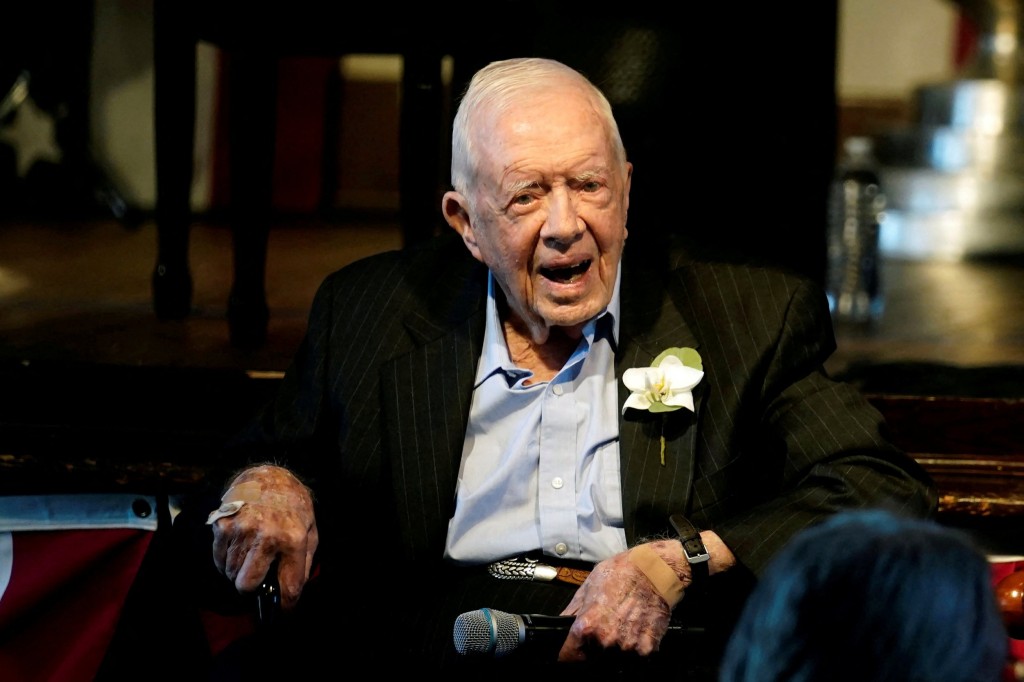 FILE PHOTO: Former U.S. President Jimmy Carter reacts as his wife Rosalynn Carter (not pictured) speaks during a reception to celebrate their 75th wedding anniversary in Plains, Georgia, U.S. July 10, 2021. John Bazemore/Pool via REUTERS/File Photo