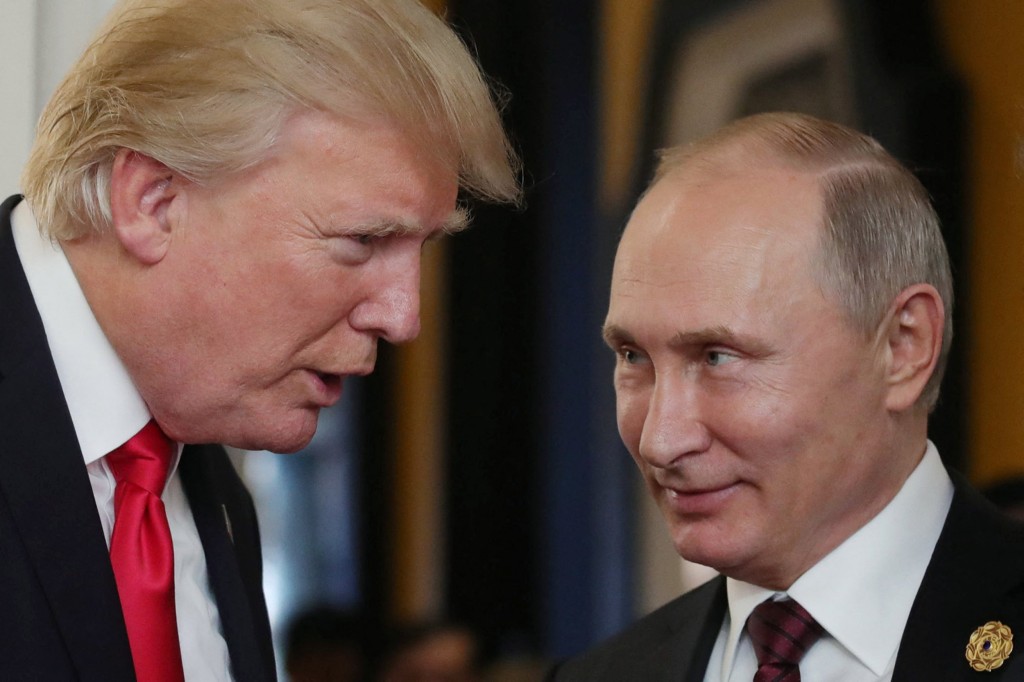 US President Donald Trump (L) chats with Russia's President Vladimir Putin as they attend the APEC Economic Leaders' Meeting, part of the Asia-Pacific Economic Cooperation (APEC) leaders' summit in the central Vietnamese city of Danang on November 11, 2017. (Photo by Mikhail KLIMENTYEV / SPUTNIK / AFP) (Photo by MIKHAIL KLIMENTYEV/SPUTNIK/AFP via Getty Images)