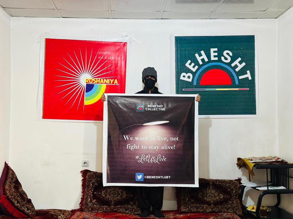 A protestor at the secret LGBTQ+ protest in Kabul, holding up a sign