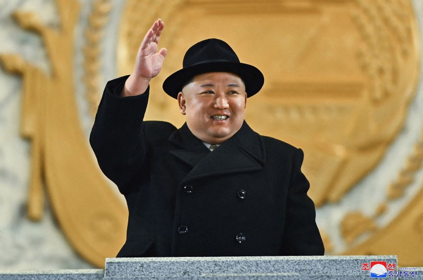 Kim Jong Un waves.