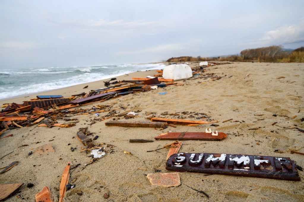 A view of parts of the wreckage of a capsized boat that was washed ashore at a beach near Cutro, southern Italy, Monday, Feb. 27, 2023. Rescue crews searched by sea and air Monday for the dozens of people believed still missing from a shipwreck off Italy???s southern coast that drove home once again the desperate and dangerous crossings of migrants seeking to reach Europe. (AP Photo/Valeria Ferraro)