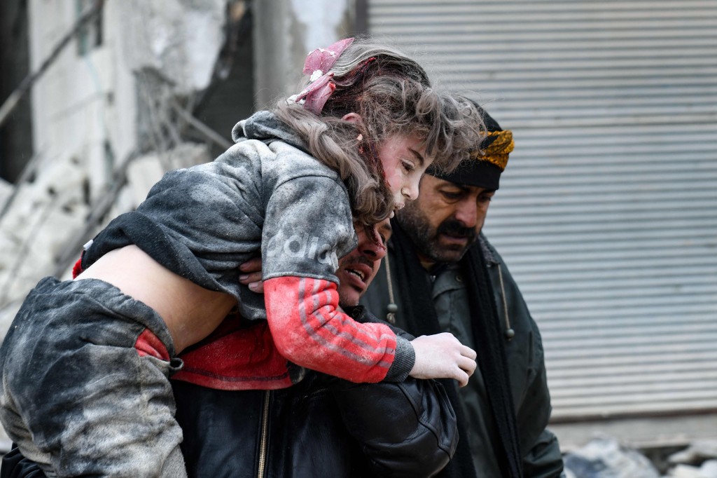 girl carried away from collapsed building