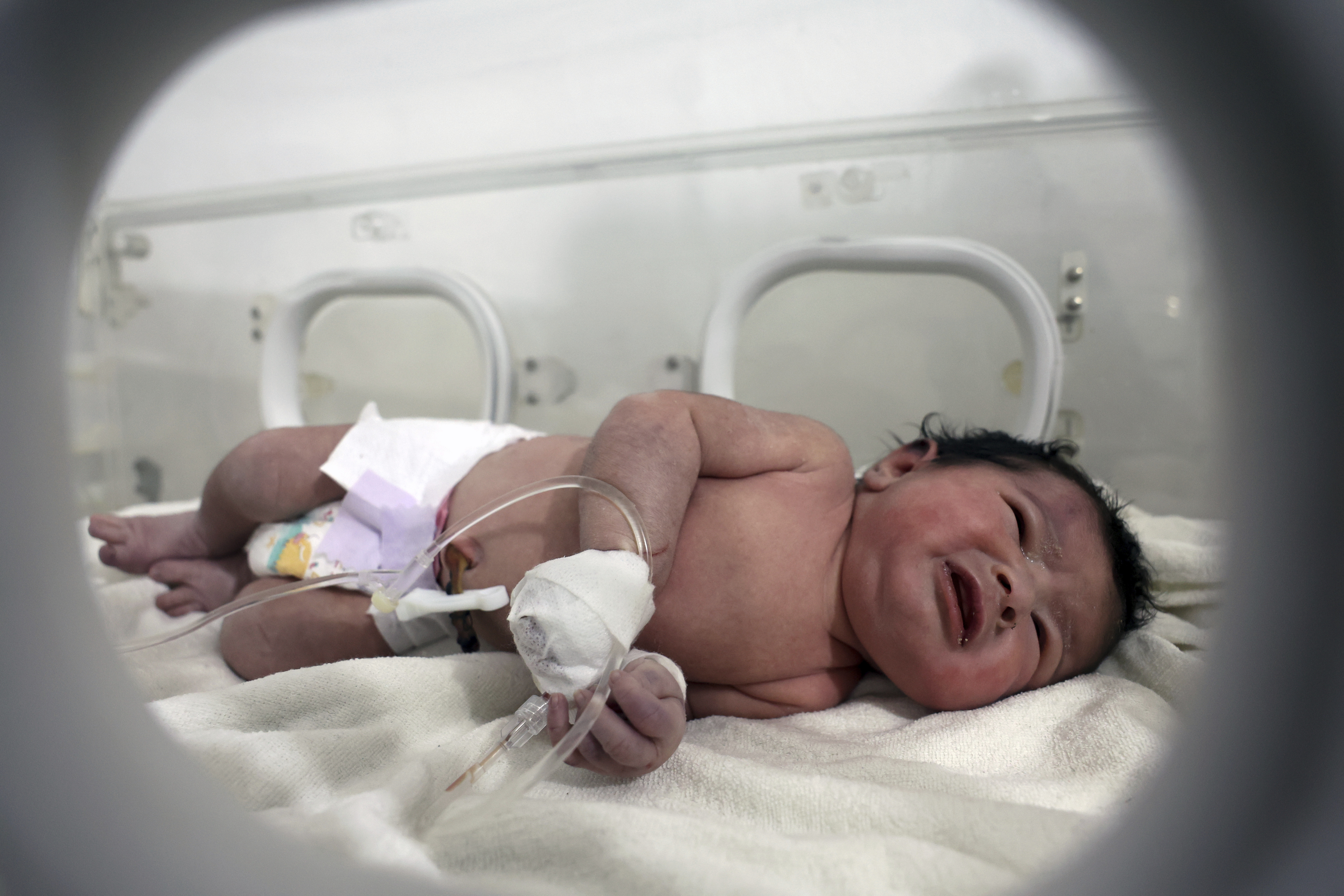 A baby girl who was born under the rubble caused by an earthquake that hit Syria and Turkey receives treatment inside an incubator at a children's hospital in the town of Afrin, Aleppo province, Syria, Tuesday, Feb. 7, 2023. The infant, who has since been named Aya, Arabic for