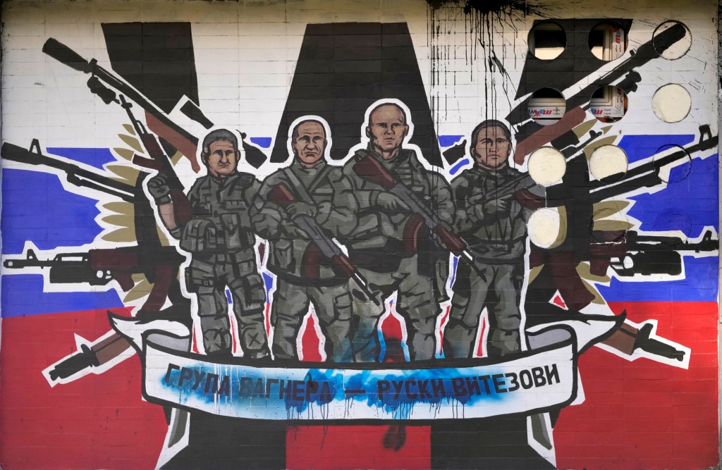 FILE - A mural depicting mercenaries of Russia's Wagner Group that reads: