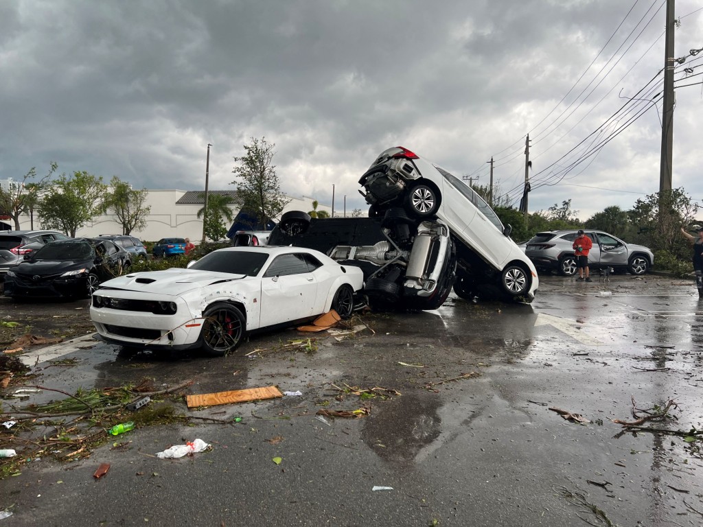 View of vehicles piled up at a parking lot following a suspected tornado, in Palm Beach Gardens, Florida, U.S., April 29, 2023 in this picture obtained from social media. Spencer Caesare/via REUTERS THIS IMAGE HAS BEEN SUPPLIED BY A THIRD PARTY. MANDATORY CREDIT. NO RESALES. NO ARCHIVES.